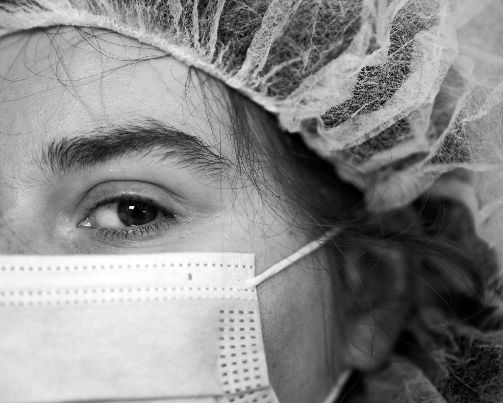 Emma, wearing her surgical gown, hair net and COVID-19 mask